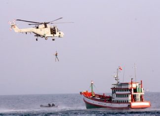 The Royal Thai Navy practices rescuing an unconscious fisherman by airlifting him via helicopter.