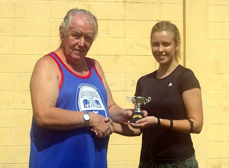 Dasha is presented with The President’s Cup by Eric Hearn.