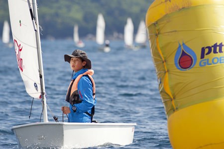 A young sailor competes in the Optimist dinghy class. (Photo by Guy Nowell)