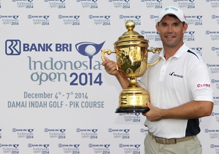 Padraig Harrington holds the champions trophy after winning the 2014 BANK BRI Indonesia Open at the Damai Indah Golf, PIK Course in Jakarta, Sunday, Dec. 7.