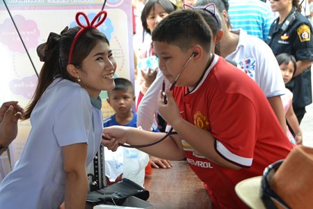 A young man plays doctor for a day courtesy of staff from the new Pattaya Hospital.