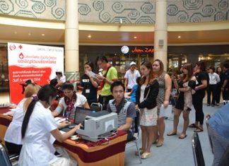 Residents and staff of Big C North Pattaya wait in line to take a blood test before donating to help people in need.