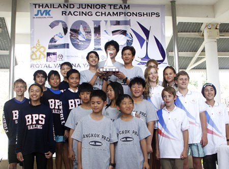 Junior sailors from Bangkok Prep. School stand atop the podium with the trophy as the teams from Bangkok Patana School (left) and Lycée Français (right) look on.