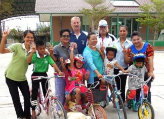 Rick Bevington, back right, along with William Macey make the latest presentation of Rick’s Bikes for Tyke program to the CPDC.