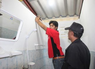 Anon Inthisit shows police how he secretly videoed a woman in a restroom in Sattahip.