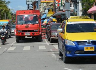 A coke truck double-parked at the northern end of Beach Road blocks traffic.