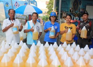 Residents of Kophai Community proudly show off their home made kaffir lime dish washing liquid.