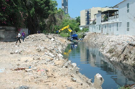 Workers clear out debris from the inland side of the canal. Deputy Mayor Verawat Khakhay predicts the remaining demolition would be complete before the rainy season.