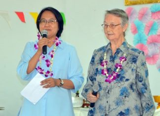 Sister Jiemjit Thumpichai and Sister Joan Gormley welcome guests to the Songkran activities at the Fountain of Life Center Pattaya.