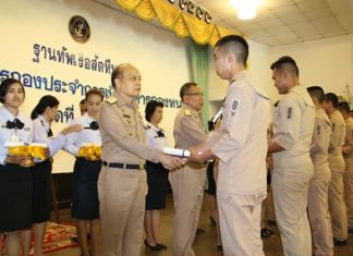 Rear Adm. Chatchawal Meesawad presents a certificate to one of 112 outgoing seamen at Sattahip Naval Base.