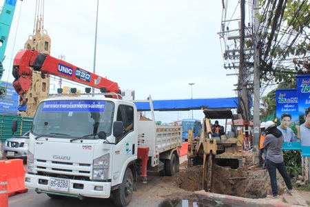 Workers begin digging holes for the new footbridge foundation piles near the Bangjak gas station.