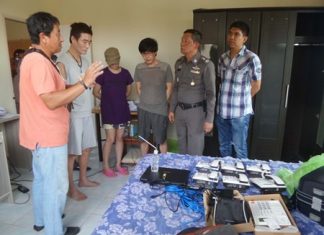 Jonggeun Kim, Duri Kim, and Kisoo Oh (standing 2nd left to 3rd right) have been arrested on immigration offenses while police look into their operating a telephone-fraud call center in Pattaya.