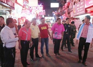 Local officials and soldiers from the 14th Military Circle in Chonburi check out shops and street vendors along Walking Street, looking for those encroaching on public property.