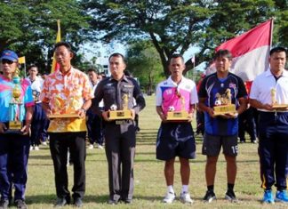 Navy team captains hold up their trophies during the closing ceremony of the Sattahip Naval Station’s internal sports competition, August 19.