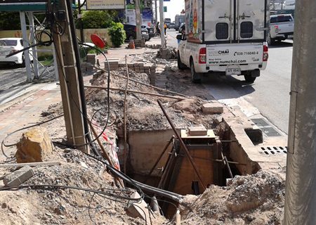 Workers from Bang Saen Mahanakhon begin repairs to bricks and drain covers caused by demolition of the street in order to relocate electrical cables and water pipes.