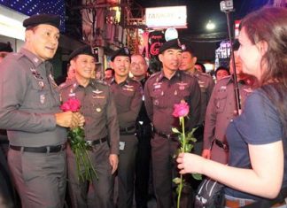 Tourist Police Region 3 deputy commander, Pol. Lt. Gen. Naret Nantachot and Tourist Police officials reach out to Pattaya tourists, offering roses on Walking Street to reassure visitors that helping tourists and preventing crime are top priorities.