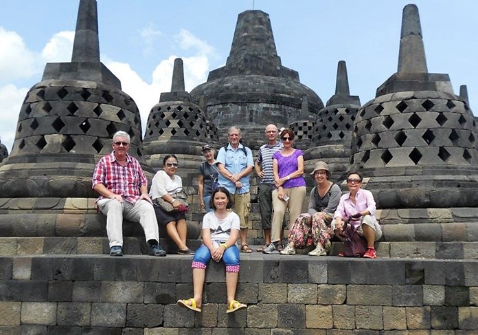 Nine members of the group pose for a picture after reaching the upper three levels at Bourabudur; “the abode of the gods.”