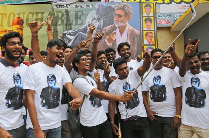 Fans of Indian superstar Rajinikanth take a selfie outside a cinema hall to celebrate the screening of “Kabali” in Chennai, India, Friday, July 22. (AP Photo/Aijaz Rahi)