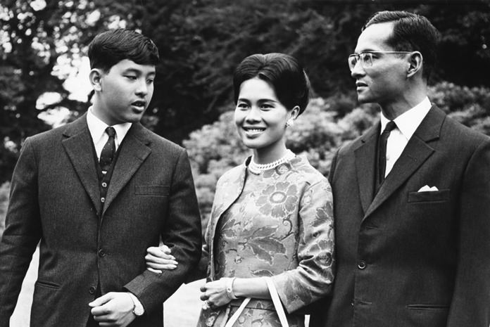 In this July 27, 1966, file photo, His Majesty King Bhumibol Adulyadej, right, walks with Her Majesty Queen Sirikit and their 13-year-old son, Crown Prince Vajiralongkorn, through the gardens of their residence at Sunninghill, Berkshire, where they were staying during their private visit to Britain. (AP Photo/Harris, File)