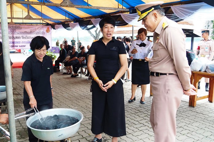 Royal Thai Navy officers are trading the deep blue sea for black dye, hoping to help ease the financial burden on those morning HM the King.