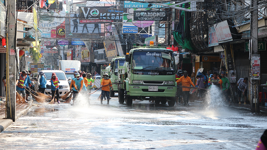 A water truck hoses down the street while workers sweep away dirt and garbage to give Walking Street a good scrubbing before next week’s Songkran party begins.