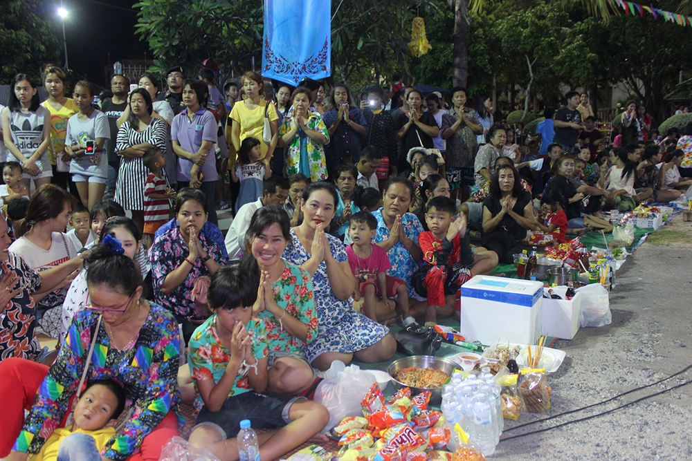 Community members lay out food and desserts to appease the spirits.