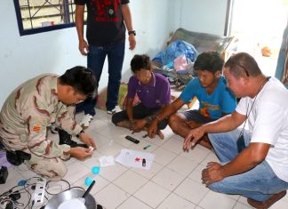 Kanchanasak Yukasen (2nd right) has been arrested for allegedly dealing methamphetamines in Sattahip.