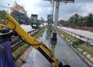 Pattaya dredged drainage canals dividing lanes on Sukhumvit Road to mitigate flooding.