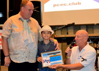 MC Roy Albiston presents Ben Rudolf with the PCEC’s Certificate of Appreciation for his musical presentation as Marcus Tristan looks on.