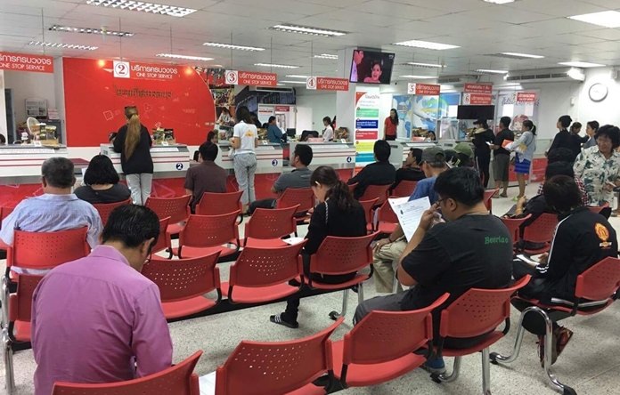 Residents queue up at Banglamung Post Office to reserve pins commemorating the cremation of King Rama IX.