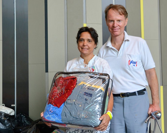 Margaret Grainger and member Ren Lexander show some of the donations brought by PCEC members and guests for the use and benefit of the Hand to Hand Foundation.