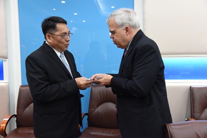 Permanent Secretary for Labor, Jarin Chakkaphark, left, greets Peter Haymond, Deputy Chief of Mission at the United States Embassy in Bangkok, Wednesday, Nov. 15.