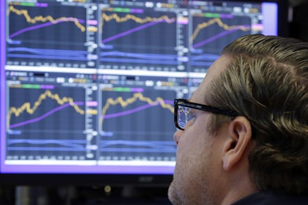 In this Monday, Dec. 4, 2017, file photo, specialist Gregg Maloney works at his post on the floor of the New York Stock Exchange. The stock market had a banner year overall, but there were plenty of big winners, and big losers, among individual U.S. companies in 2017. (AP Photo/Richard Drew, File)