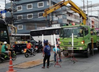 Road workers repair a collapsed section of Thepprasit Road following complaints from locals.