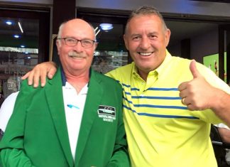 Phil Davies (right) presents a green jacket to John Anderson.