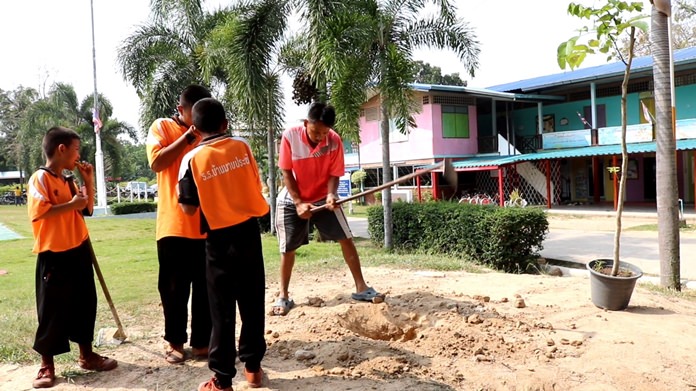 Volunteers Group 9099 clean up Mabprachan School as part of their community service program.