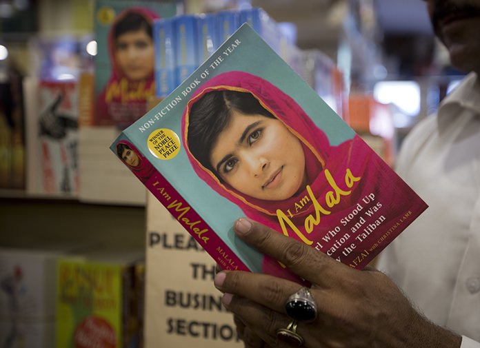 A Pakistani customer looks over Nobel Peace Prize winner Malala Yousafzai’s book at a book store in Islamabad, Pakistan. (AP Photo/B.K. Bangash)