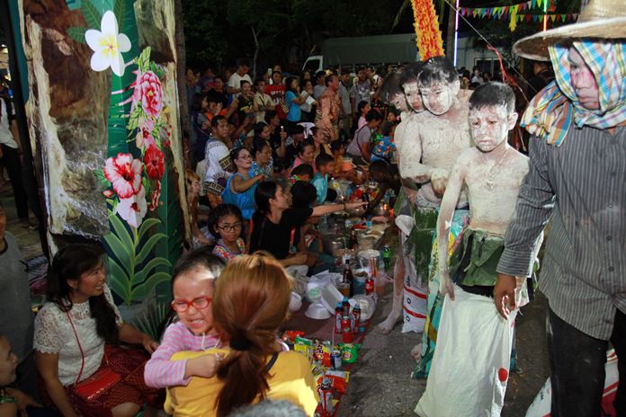 The initial rice piling takes place at Lan Pho Park, where food is prepared for the spirits.