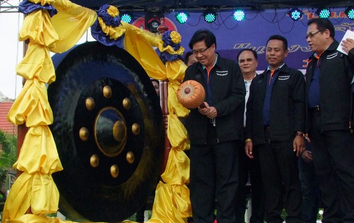 Chonburi Deputy Gov. Chaichan Iamcharoen strikes the huge gong declaring the May Day festivities open.