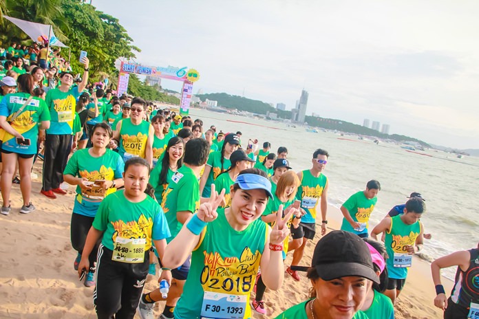 Participants in the 6 kilometer walk run soak up the party atmosphere as they cross the start line.