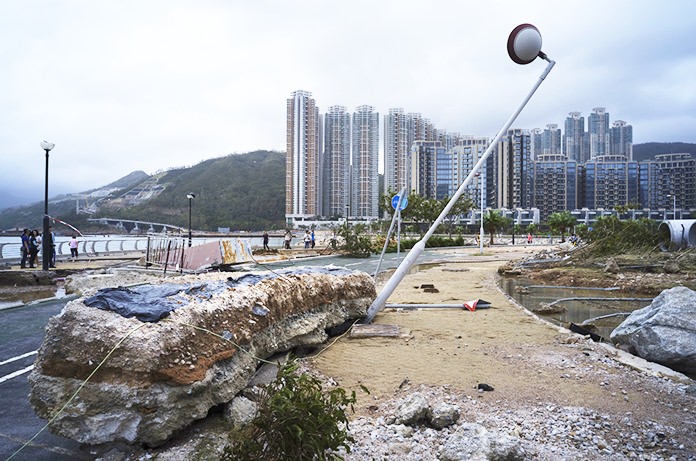 Hong Kong and southern China hunkered down as strong winds and heavy rain from Typhoon Mangkhut lashed the densely populated coast. The biggest storm of the year left dozens dead from landslides and drownings as it sliced through the northern Philippines. (AP Photo/Vincent Yu)