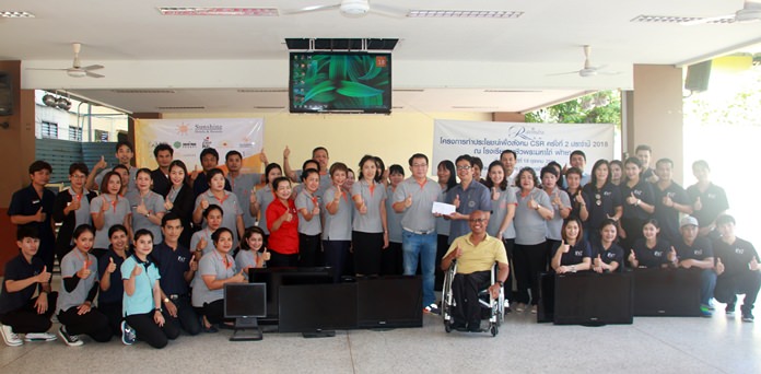 The Sunshine hotels group Executive Director Thana Supornsahatrangsi presents a donation of 23,900 baht and damaged electronics and appliances for vocational students to use in their studies at the Redemptorist Vocational School for Persons with Disabilities.