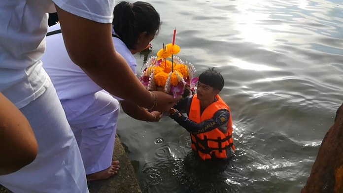 Participants float krathongs carrying incense and candles as well as paper wishes and fake money.