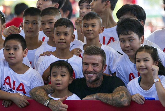 Retired footballer David Beckham poses for a group photograph during a sponsored promotional event in Bangkok, Saturday, Nov 3. (AP Photo/Gemunu Amarasinghe)