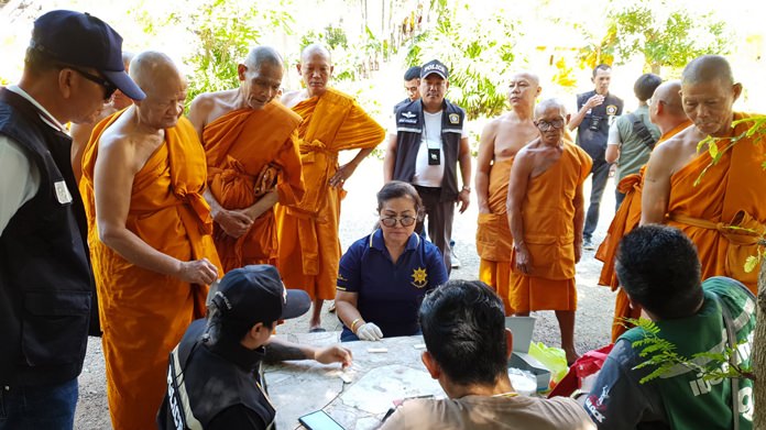 Sattahip District Chief Anucha Intasorn, police and village chiefs witness the Dec. 13 drug tests by 35 monks, all of whom passed.