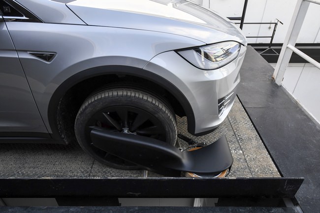 The modified Tesla Model X rests on an elevator above the pit and tunnel entrance. (Robyn Beck/Pool Photo via AP)