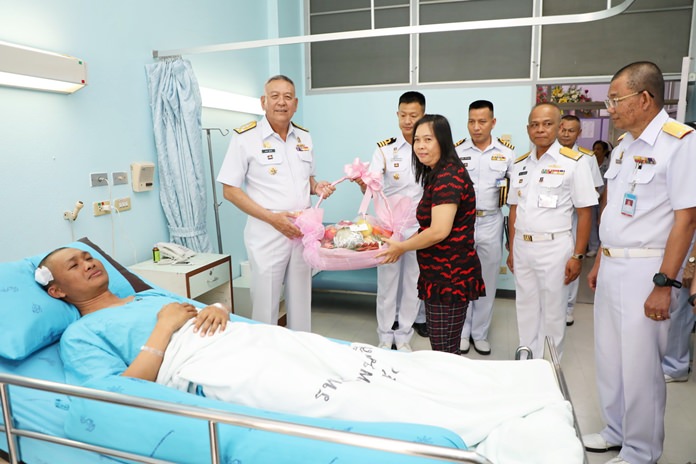 Adm. Noppadol Supakorn arrives with a flower basket and compensation money for Petty Officer 1st Class Boonsom Promchart at Queen Sirikit Naval Medical Center in Sattahip.