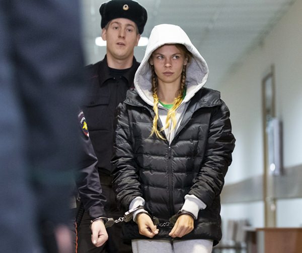 Anastasia Vashukevich, also known on social media as Nastya Rybka is escorted in the court room in Moscow, Russia, Saturday, Jan. 19, 2019. She was arrested upon arrival in Moscow following deportation from Thailand. (AP Photo/Alexander Zemlianichenko)