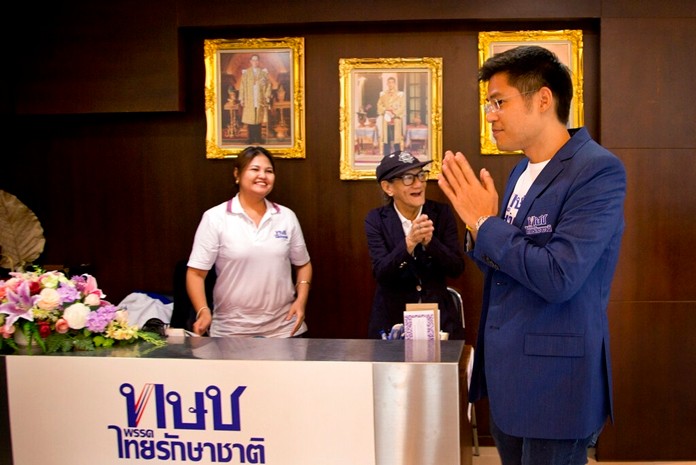 The leader of the Thai Raksa Chart political party Preechapol Pongpanich, right, greets officials at party head-office in Bangkok, Wednesday, Feb. 13. (AP Photo/Gemunu Amarasinghe)