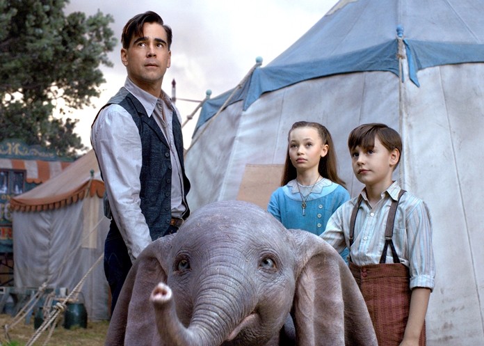 This image shows Colin Farrell, Nico Parker and Finley Hobbins in a scene from “Dumbo.” (Disney via AP)